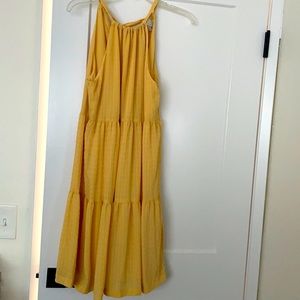 Tied neck fun sun dress. It’s mid-length and a soft “corn” color. Never worn.